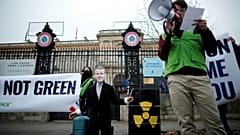 A Green activist attends a protest to denounce French push to include nuclear energy and fossil gas in the EU Green taxonomy. 