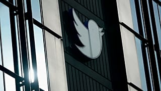 A Twitter logo hangs outside the company's offices in San Francisco, on Dec. 19, 2022.