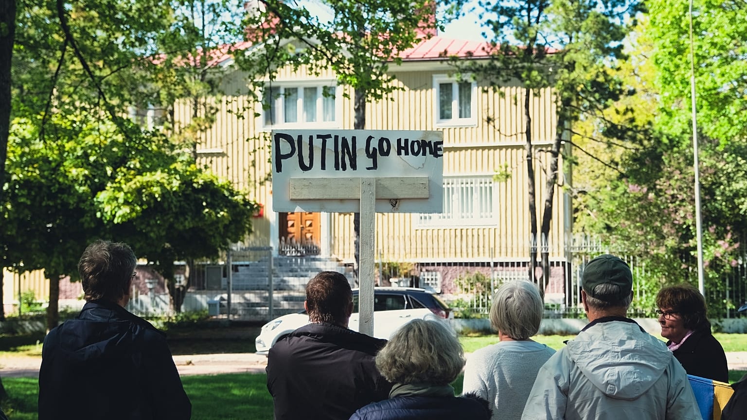 FILE: A man holds a sign reading "Putin Go Home" during a protest in front of the Russian Consulate in Mariehamn, Aland, Finland on June 1, 2022.