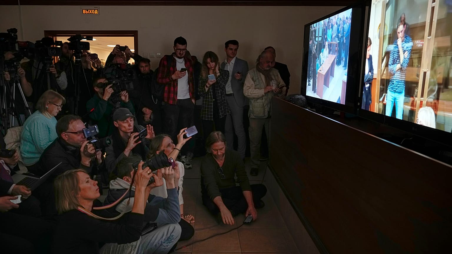 Journalists watch a TV screen broadcasting hearing on Wall Street Journal reporter Evan Gershkovich's case from a courtroom at the Moscow City Court, in Moscow, Russia.