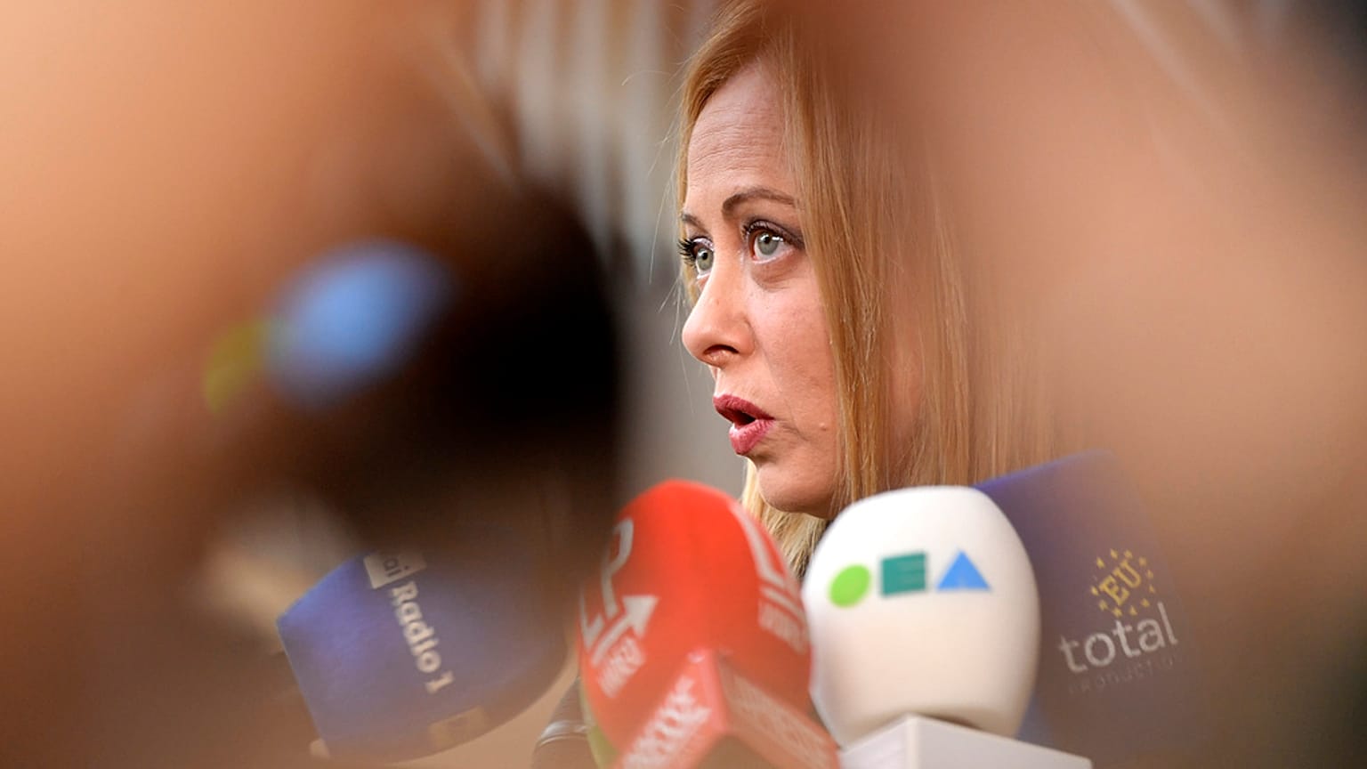 Italy's Prime Minister Giorgia Meloni speaks with the media as she arrives for an EU summit at the European Council building in Brussels, March 23, 2023