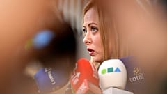 Italy's Prime Minister Giorgia Meloni speaks with the media as she arrives for an EU summit at the European Council building in Brussels, March 23, 2023