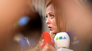 Italy's Prime Minister Giorgia Meloni speaks with the media as she arrives for an EU summit at the European Council building in Brussels, March 23, 2023