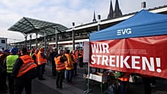 Railway workers protest in front of the Cologne Central Station during a nationwide strike.