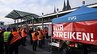 Railway workers protest in front of the Cologne Central Station during a nationwide strike.