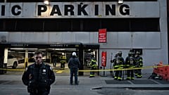 Members of the Fire Department of New York (FDNY) and New York Police Department (NYPD) work at the scene of a parking garage that collapsed in lower Manhattan, New York City,