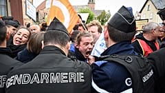 French police push back demonstrators during a protest against a visit of French President Emmanuel Macron, in Muttersholtz, eastern France on April 19, 2023.