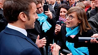 French President Emmanuel Macron argues with a person opposed to the pension reform, in Selestat, eastern France, Wednesday, April 19, 2023.