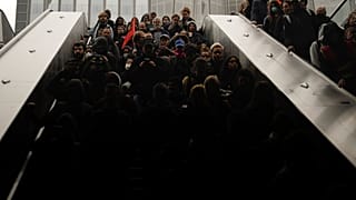 Demonstrators ride an escalator as they stage a protest against the pension reforms next to the Euronext Paris building at La Defense business district in Paris, Thursday.