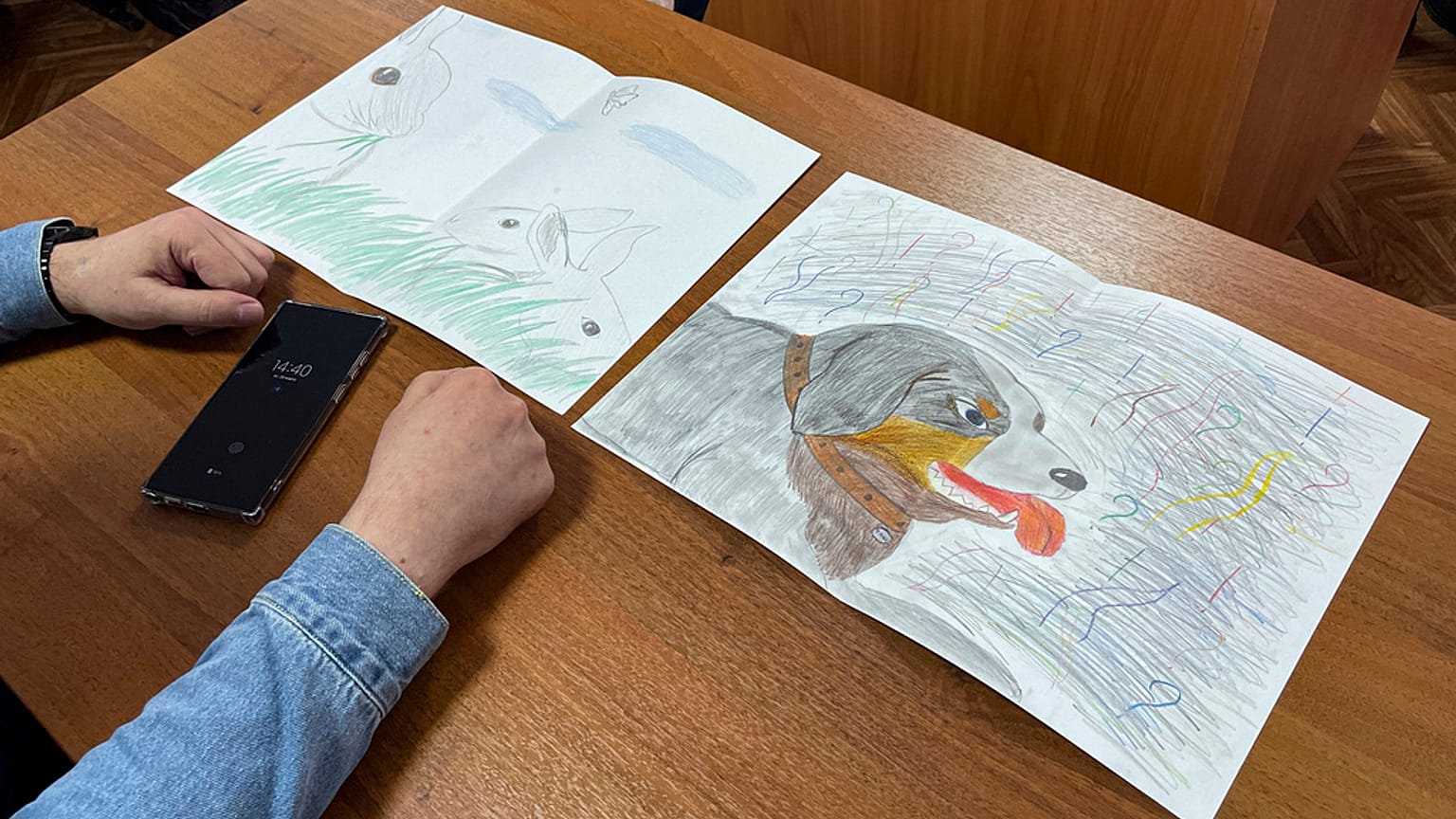 Moskalev's lawyer Vladimir Biliyenko shows drawings that Maria Moskaleva, daughter of Alexei  Moskalev, drew for her father in a courtroom
