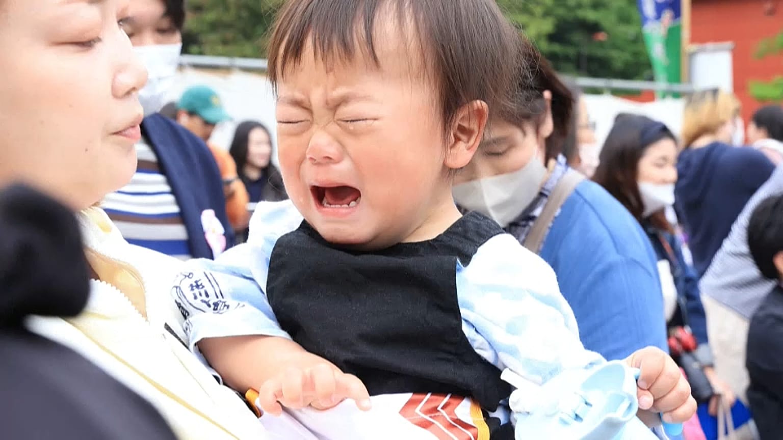 A crying child in Japan prepares for his battle in the crying sumo competition 
