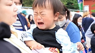 A crying child in Japan prepares for his battle in the crying sumo competition 