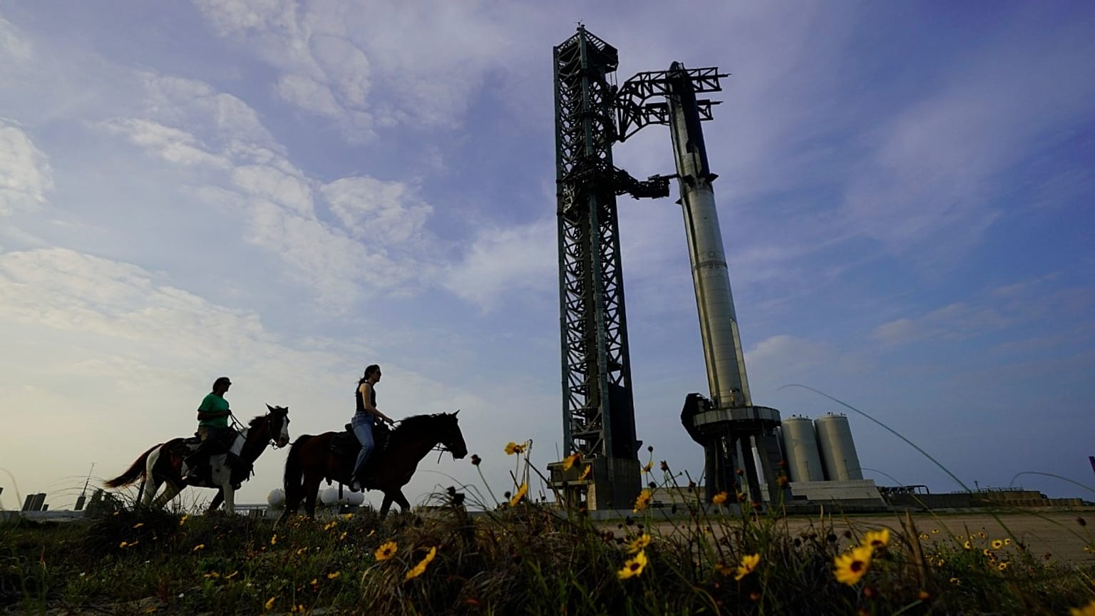 NASA astronaut Sunita Williams, left, and Haley Esparza, ride horseback as they visit SpaceX's Starship, 19 April 19 2023.
