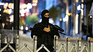 A police officer stand at the entrance on Istanbul's popular pedestrian Istiklal Avenue, late Sunday, Nov. 13, 2022. 