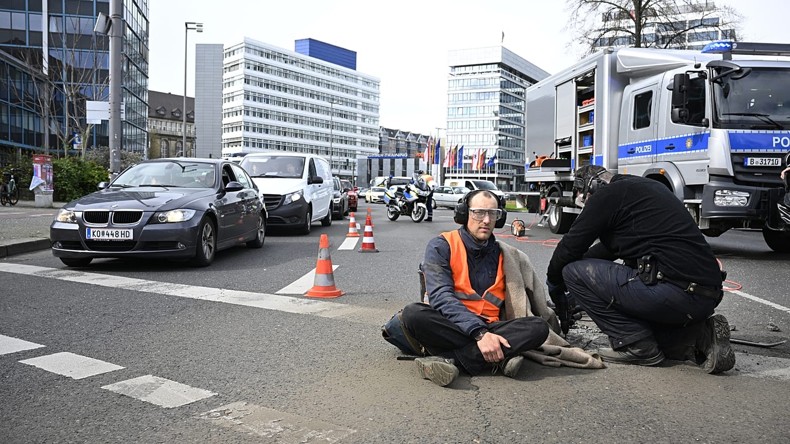 Police remove an activist from the road near Berlin's Ernst-Reuter-Platz central place. 