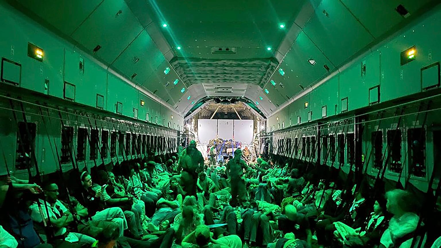 In this photo provided by the Spanish Defence Ministry citizens of different nationalities, fleeing from Sudan, sit inside a Spanish Air Force aircraft on its way to Madrid.