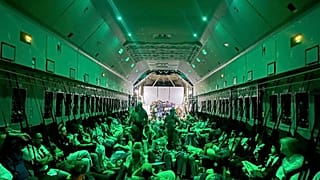In this photo provided by the Spanish Defence Ministry citizens of different nationalities, fleeing from Sudan, sit inside a Spanish Air Force aircraft on its way to Madrid.