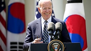 President Joe Biden takes his sunglasses off at a news conference with South Korea's President Yoon Suk Yeol in the Rose Garden of the White House.