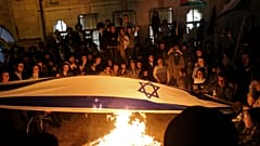 أعضاء من الحركة يحرقون أعلام إسرائيل ويلوحون بالأعلام الفلسطينية 