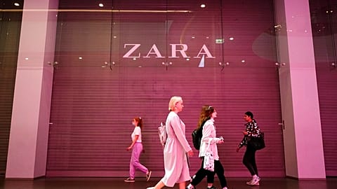 People walk past a Zara shop closed due to sanctions in a shopping mall in St. Petersburg, Russia, Tuesday, May 31, 2022.