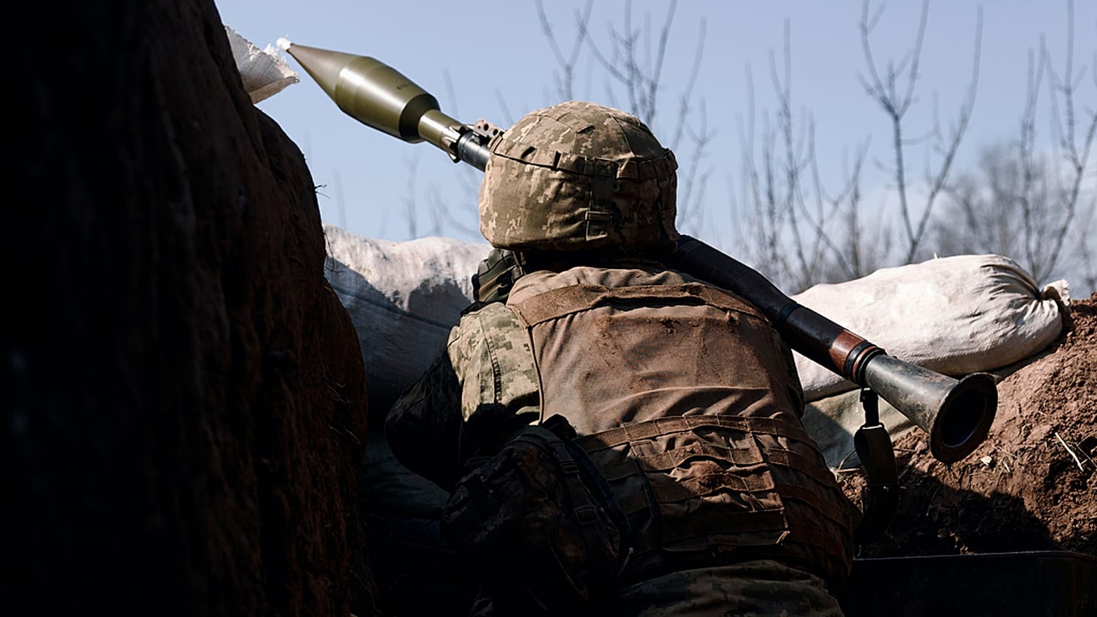 A Ukrainian soldier ires a grenade launcher on the frontline during a battle with Russian troops near Bakhmut, Donetsk region, Ukraine, Friday, March 24, 2023. 
