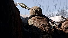 A Ukrainian soldier ires a grenade launcher on the frontline during a battle with Russian troops near Bakhmut, Donetsk region, Ukraine, Friday, March 24, 2023. 