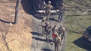 Image made from video provided by WCVB-TV of Jack Teixeira being taken into custody by armed tactical agents. 13 April 2023
