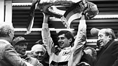 Brazilian Formula One race driver Ayrton Senna da Silva, center, holds up the winner's crown after he won the Mercedes 190 E race in Nuremberg, Germany on May 13, 1984