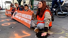 Last Generation activists block a road amid a protest in Berlin.