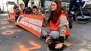 Last Generation activists block a road amid a protest in Berlin.