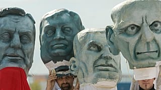 Bosnian protesters wear masks depicting the country’s political leaders outside the NATO headquarters, Base Camp Butmir, near Sarajevo. 9 October 2009