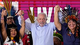 Brazilian President Luiz Inacio Lula da Silva stands between Indigenous Peoples Minister Sonia Guajajara, and National Indigenous Foundation President Joenia Wapichana