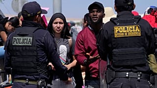 Venezuelan migrants speak with Peruvian police guarding the border with Chile in Tacna, Peru, Friday, April 28, 2023.