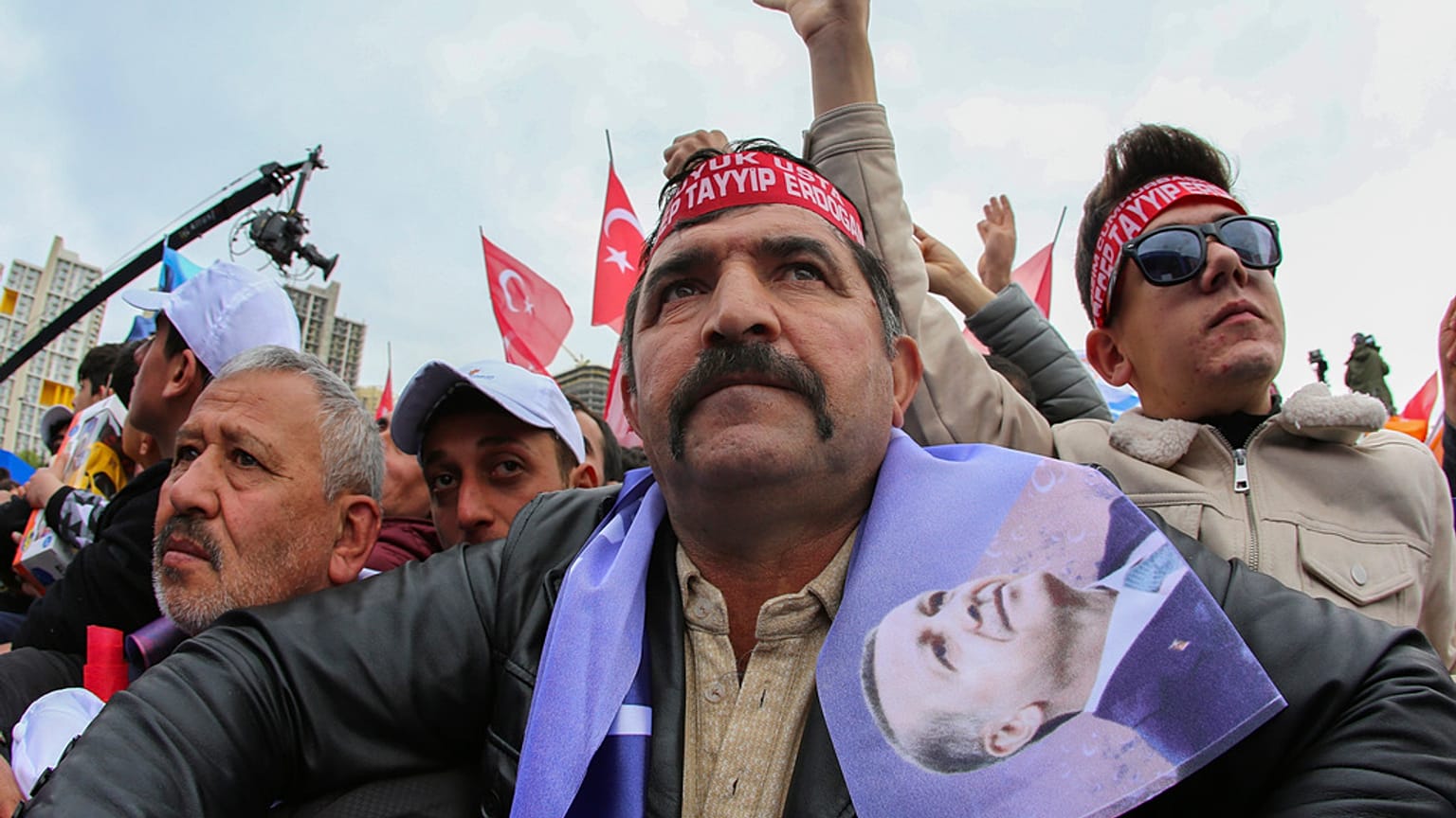 People listen to Turkish President and People's Alliance's presidential candidate Recep Tayyip Erdogan during an election campaign rally in Ankara, Sunday, April 30, 2023.