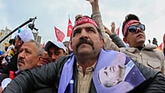 People listen to Turkish President and People's Alliance's presidential candidate Recep Tayyip Erdogan during an election campaign rally in Ankara, Sunday, April 30, 2023.