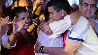 Santiago Peña, presidential candidate of the Colorado ruling party, right, embraces former President Horacio Cartes after the voting closed during general elections.