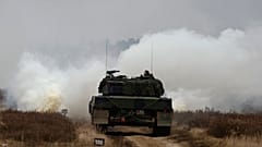 Ukrainian and Polish soldiers drive the Leopard 2 tank during a training at a military base and test range in Swietoszow, Poland, Monday, Feb. 13, 2023. 