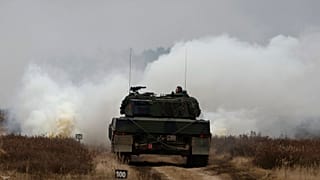 Ukrainian and Polish soldiers drive the Leopard 2 tank during a training at a military base and test range in Swietoszow, Poland, Monday, Feb. 13, 2023.