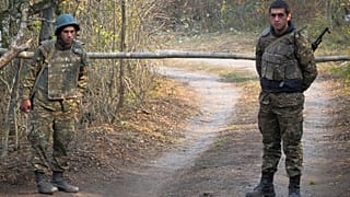 FILE: Ethnic Armenian soldiers stand at the checkpoint near the front line during a military conflict in separatist region of Nagorno-Karabakh, Monday, Nov. 2, 2020.