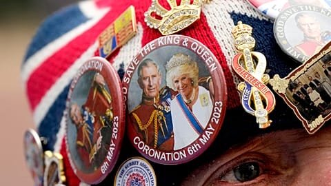 Royal fan John Loughrey speaks to passerby along the King's coronation route at The Mall in London, Tuesday, May 2, 2023.