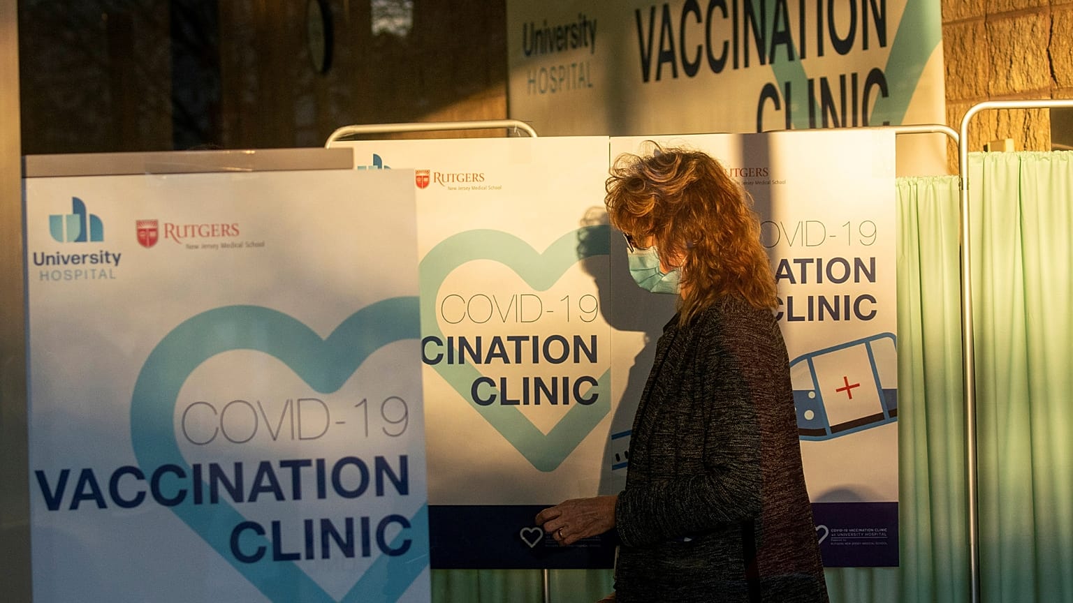 A health worker passes by the area where people get vaccinated at a hospital in the US. 