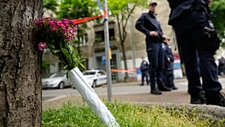 Flowers for victims are laid outside the Vladislav Ribnikar school in Belgrade, Serbia, Wednesday, May 3, 2023.