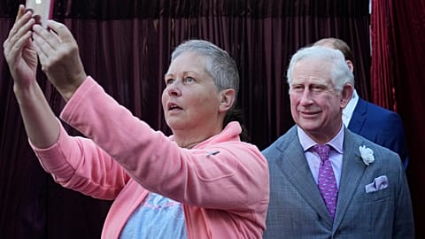 "Say cheese!" A woman photographs herself with a wax figure of King Charles III in the forecourt of the Queen Victoria Building in Sydney, Wednesday, May 3, 2023.