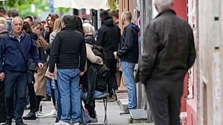 People wait in front of the Vladislav Ribnikar school after shooting in Belgrade, Serbia, Wednesday, May 3, 2023. 