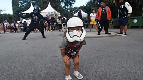 A young fan with a Stormtrooper mask looks on during a festival marking Star Wars Day