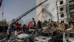 Following a Russian attack, first responders remove rubble at a residential building in Uman, central Ukraine