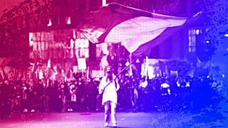 A man waves a flag outside Romania's government headquarters during an anti-government protest organised by the far-right AUR party, Bucharest, October 2021