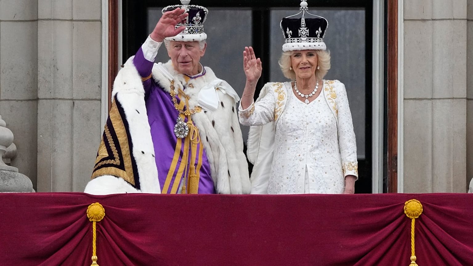 Britain's King Charles III and Queen Camilla wave to the crowds from the balcony of Buckingham Palace after the coronation ceremony in London, Saturday, May 6, 2023. 