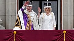 Britain's King Charles III and Queen Camilla wave to the crowds from the balcony of Buckingham Palace after the coronation ceremony in London, Saturday, May 6, 2023. 