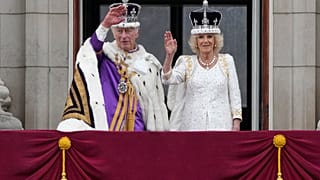 Britain's King Charles III and Queen Camilla wave to the crowds from the balcony of Buckingham Palace after the coronation ceremony in London, Saturday, May 6, 2023.